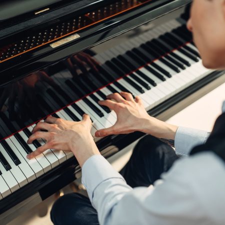 Pianist playing music on grand piano